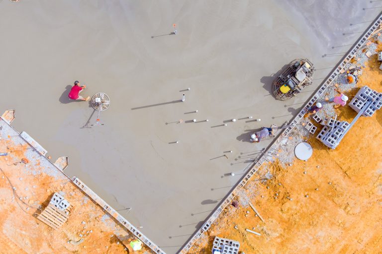 After pouring concrete foundation, leveling was done by workers using a concrete polishing machine