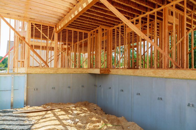 New home Construction of a cement block home with wooden roof trusses.